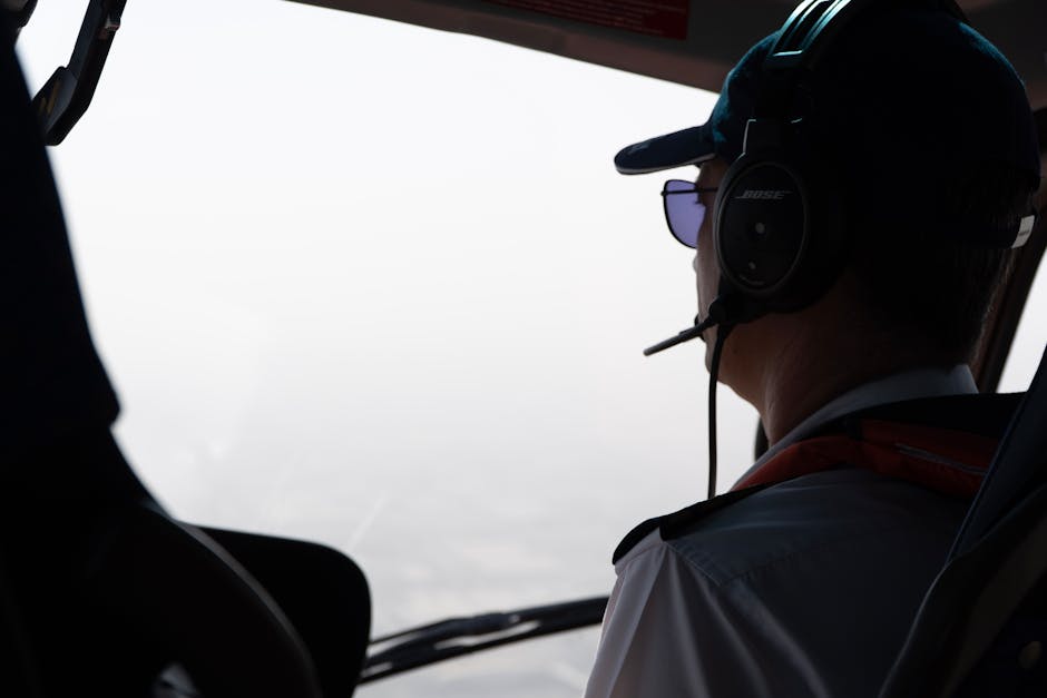 A pilot of a private jet charter in the cockpit flying the plane to it's destination